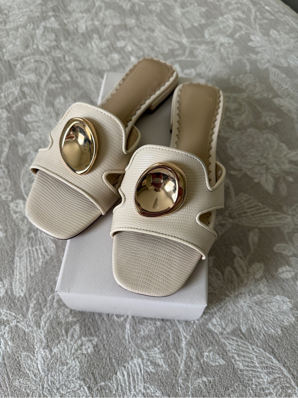 ANTONIO MELANI Cream Slide Mules with Gold Medallion